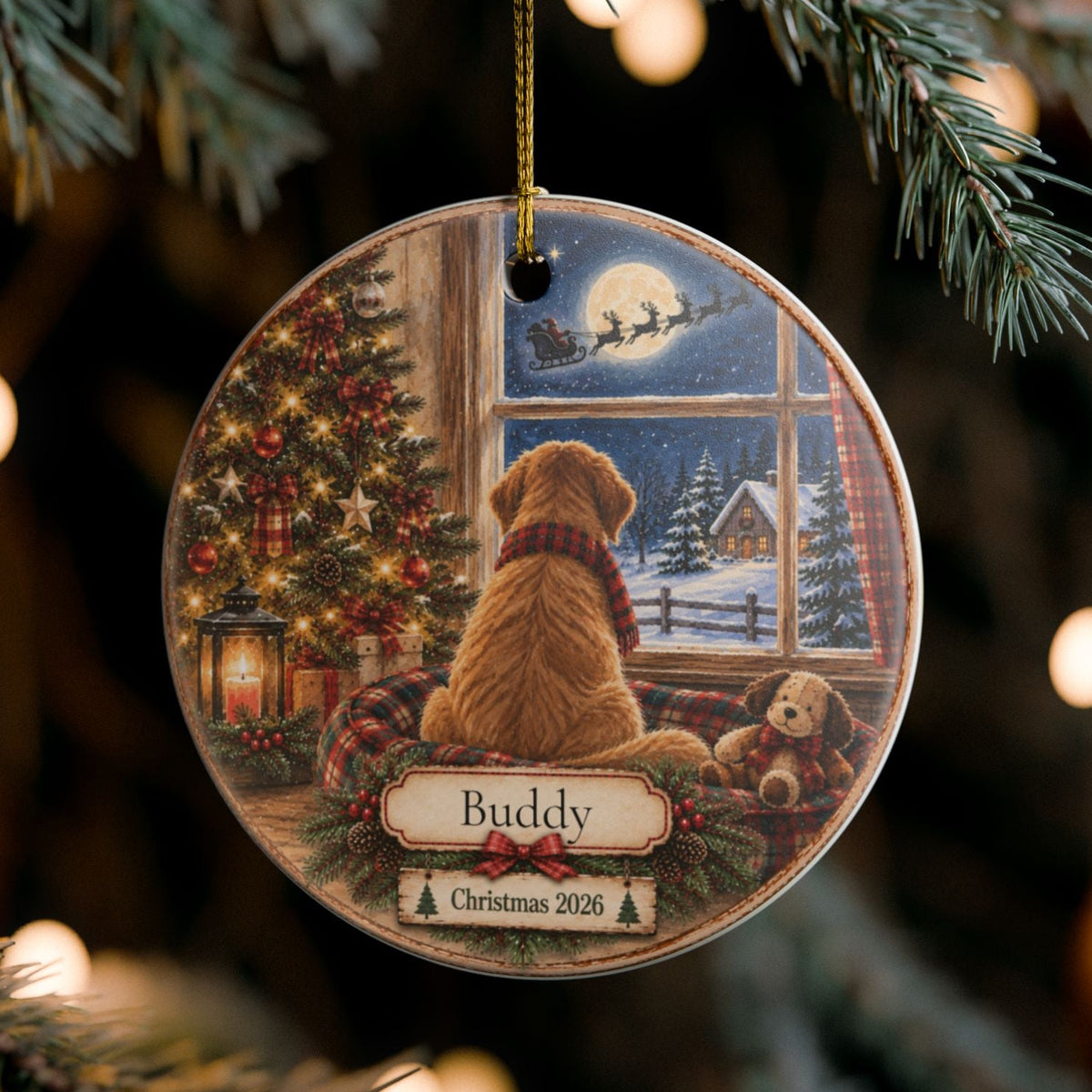 A round ceramic Christmas ornament hanging from a pine tree branch. The ornament features an illustration of a golden retriever dog sitting by a window, looking out at a snowy winter night with Santa Claus in the sky.