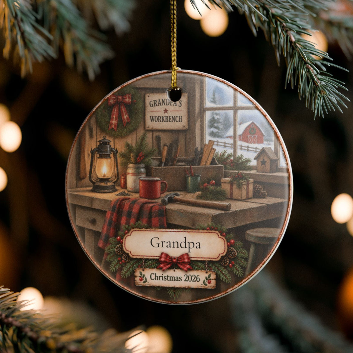 A round Christmas ornament hanging from a pine tree branch at night, featuring a rustic workshop scene with the word 'Grandpa' and the date 'Christmas 2026' on the front.